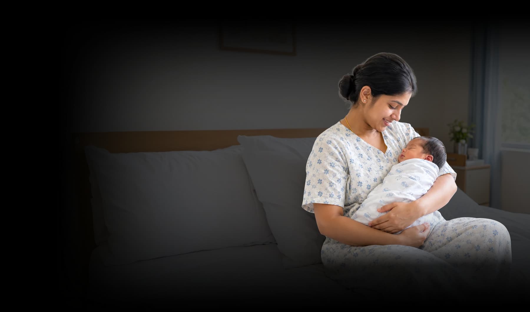 A mother cradles her newborn baby