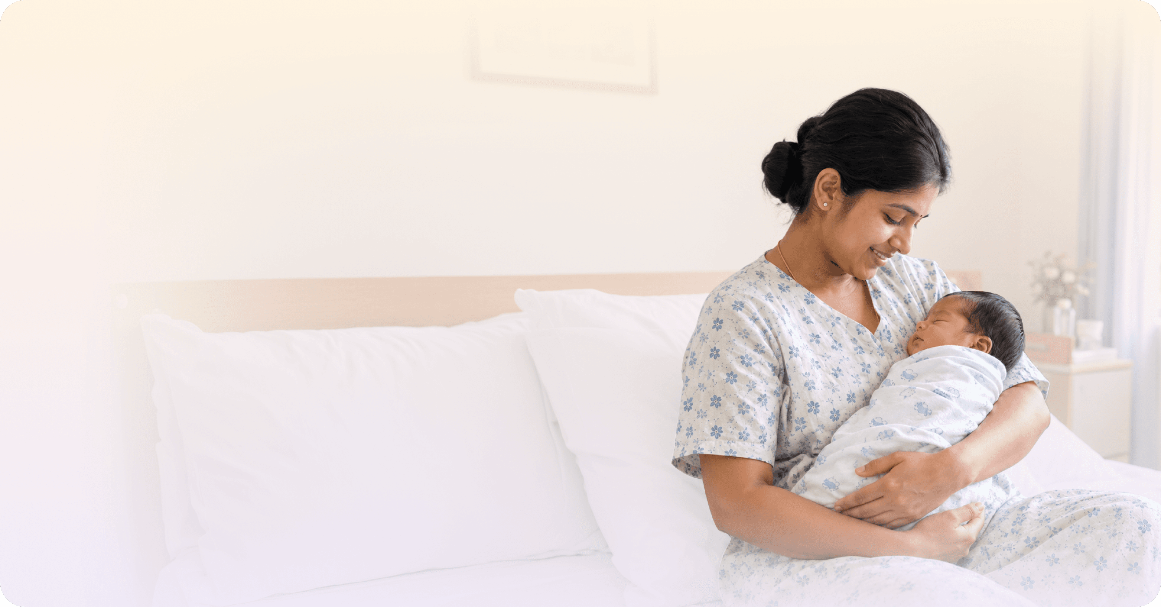A mother cradles her newborn baby